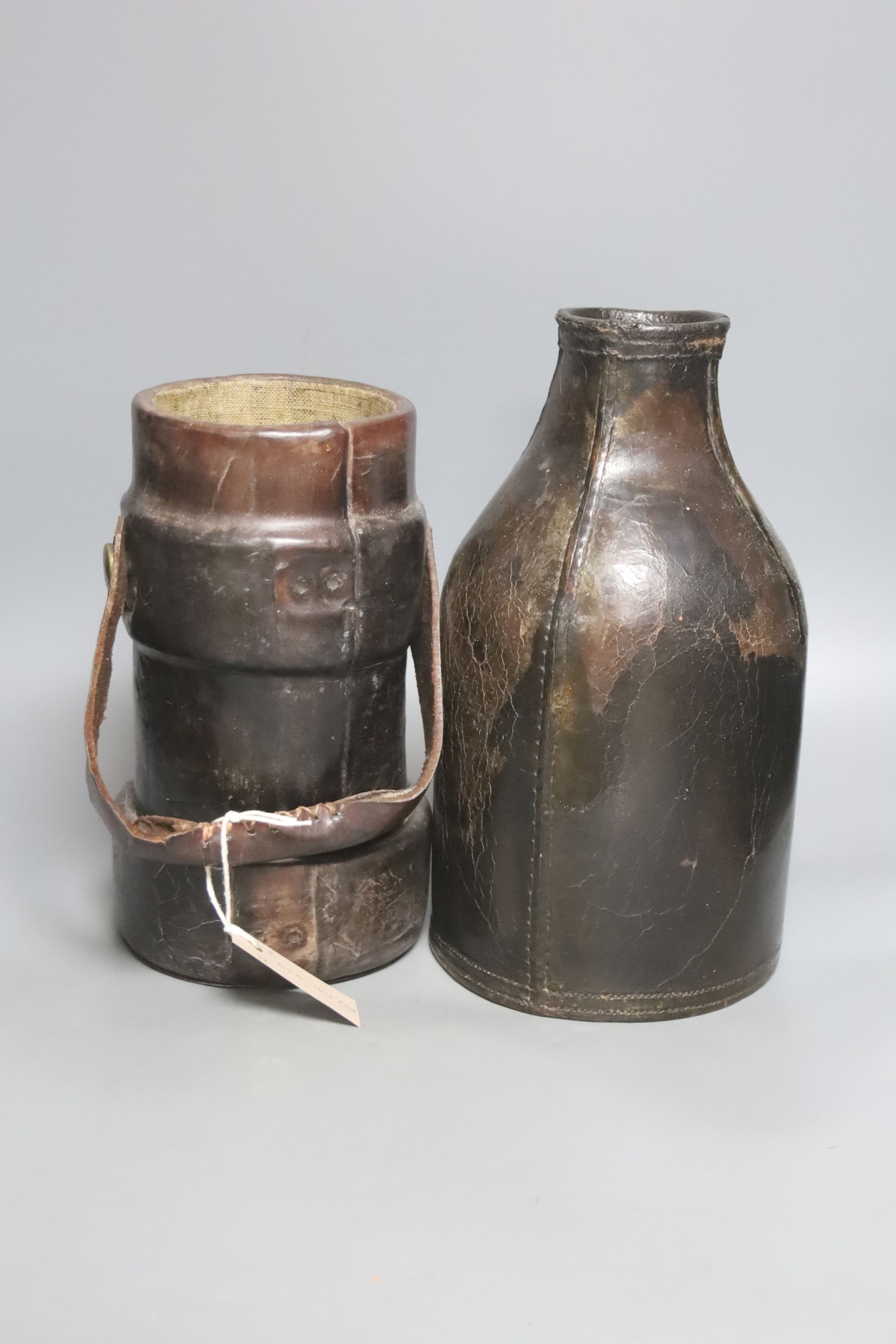 An 18th century leather bottle or blackjack and a WWII leather shell carrier